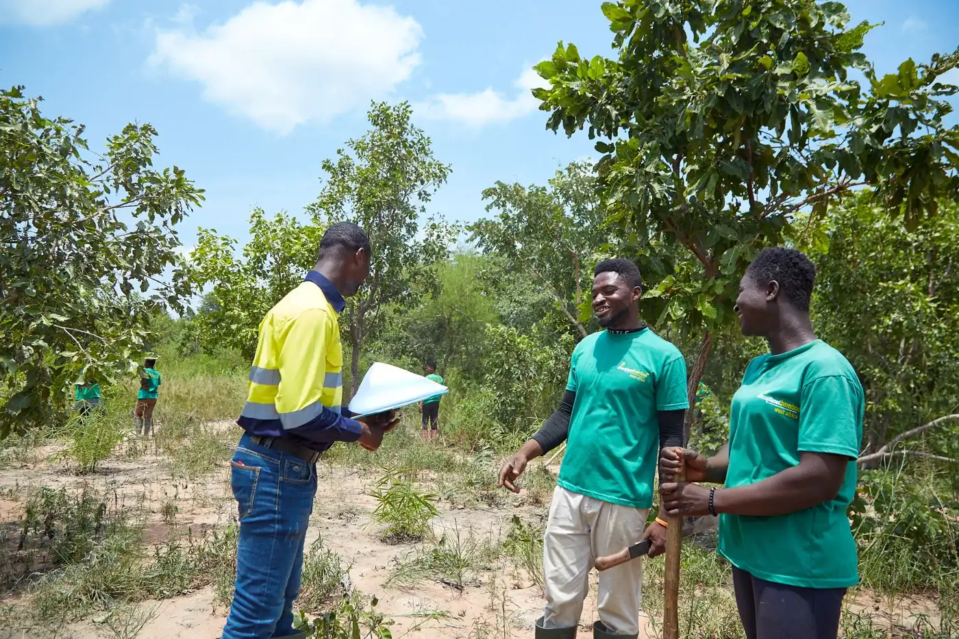 An EcoPlanet supervisor reviewing records with a colleague