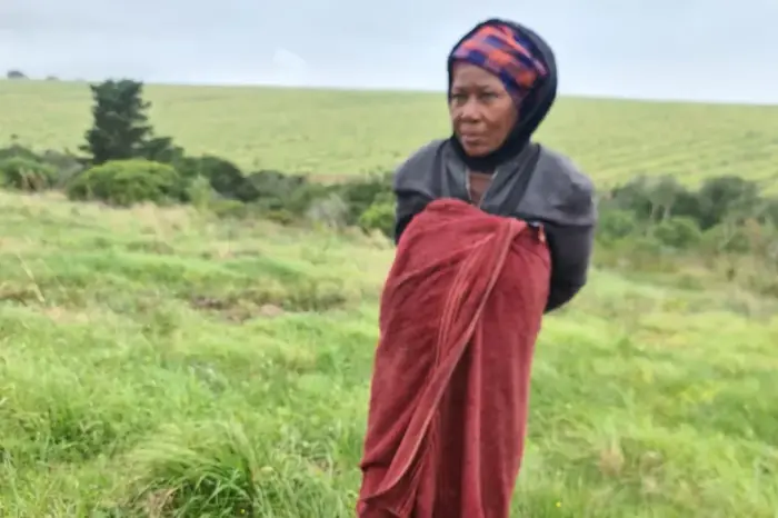A woman carrying a bag of African spinach harvested on the farm