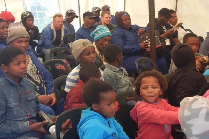 Workers and community members at an environmental education session
