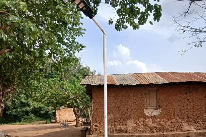 A solar-powered street light in one of the project communities
