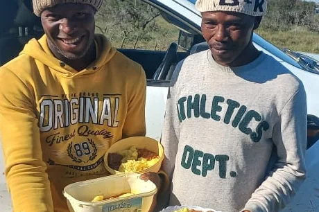Farm workers receiving cooked meals near Makhanda